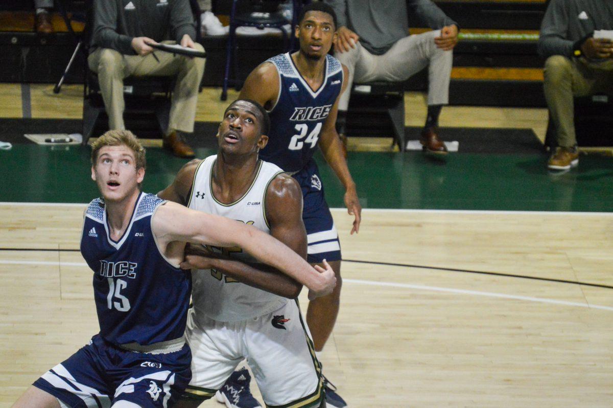 Trey Jemison is defended by a Rice player | Caleb Wood