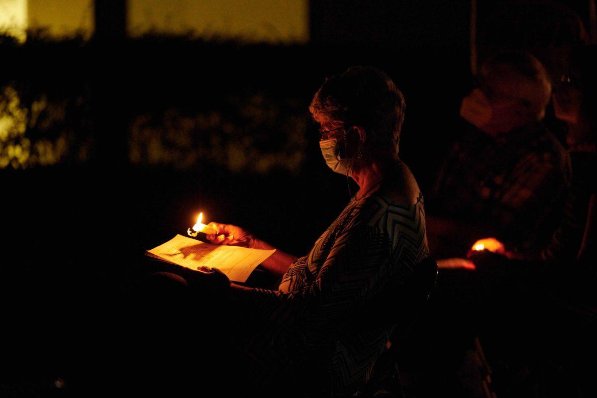 A woman holds a candle at a vigil for Medicaid expansion | Photo by Dawson Martin