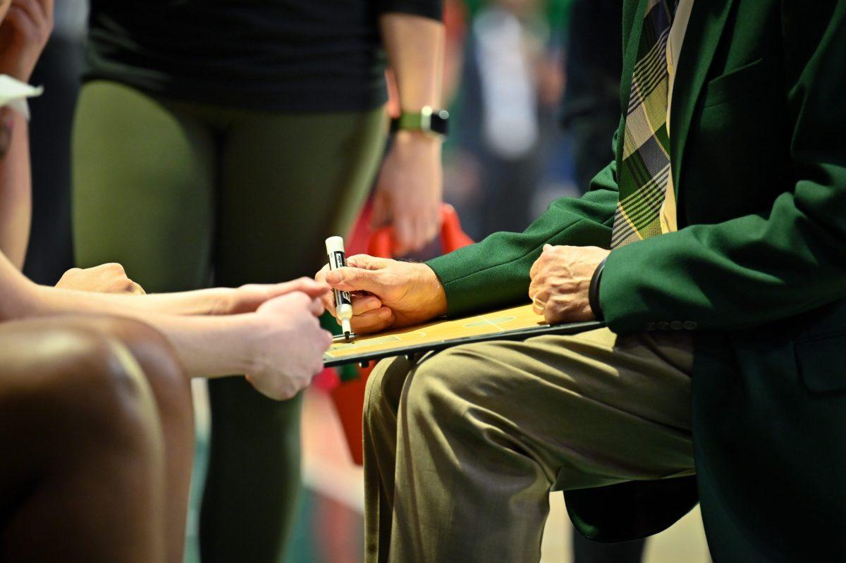 Women's basketball coach Randy Norton draws up a play | Photo by Dawson Martin