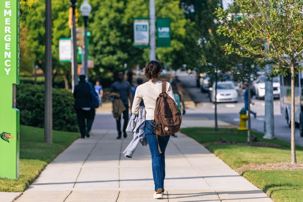 A student walks across campus near University Boulevard. (Photo Courtesy of UAB Digital Access Library)